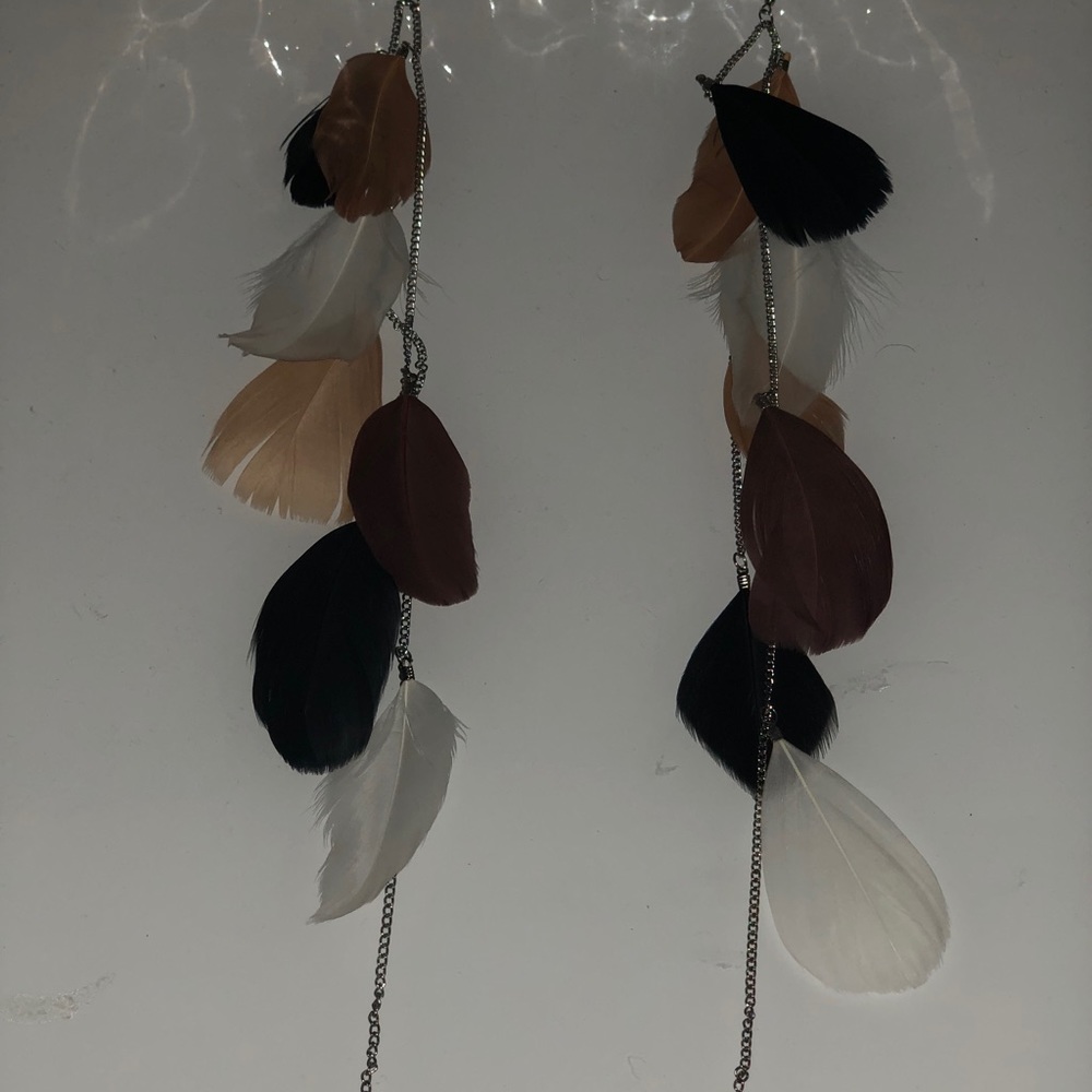 Long feathered earrings.